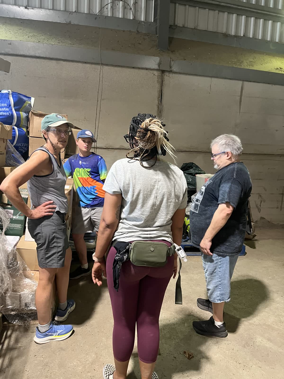 Volunteers sorting boxes of supplies inside the loading barn