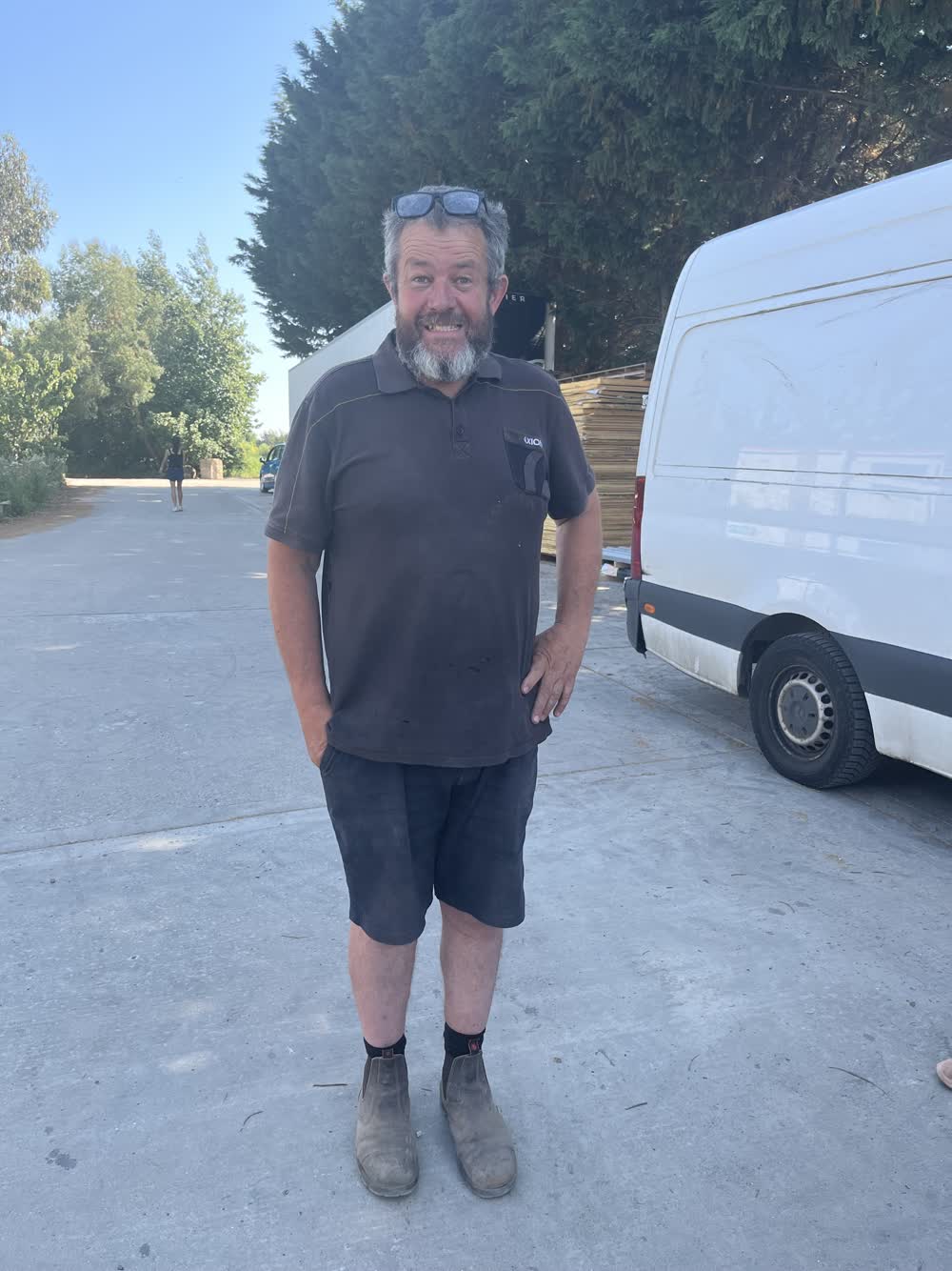 James Baird standing on the yard at Church Farm beside one of the convoy vans