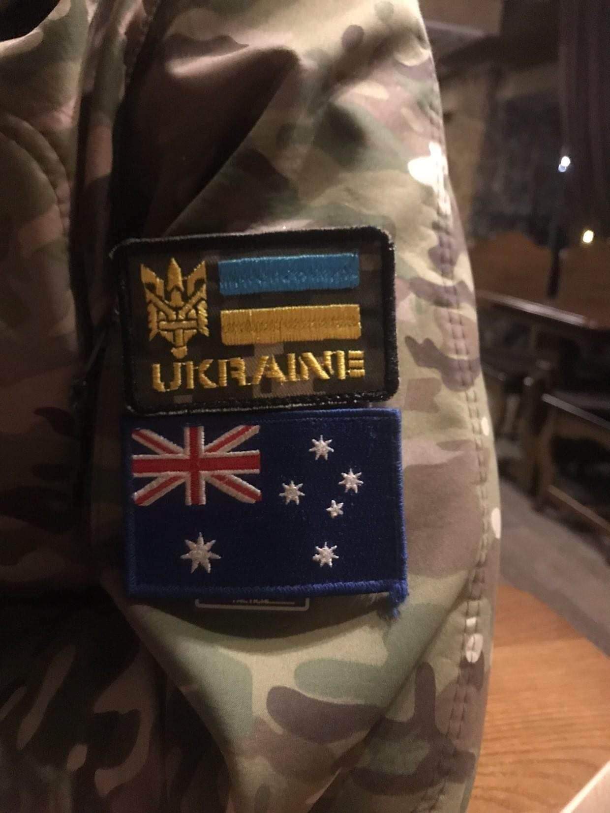 Ukraine and Australia flag patches on a soldier's uniform - Medaria Aid founders' sons serve on the front lines