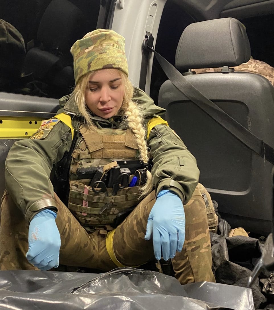 Female Ukrainian frontline medic in full gear, exhausted after a mission